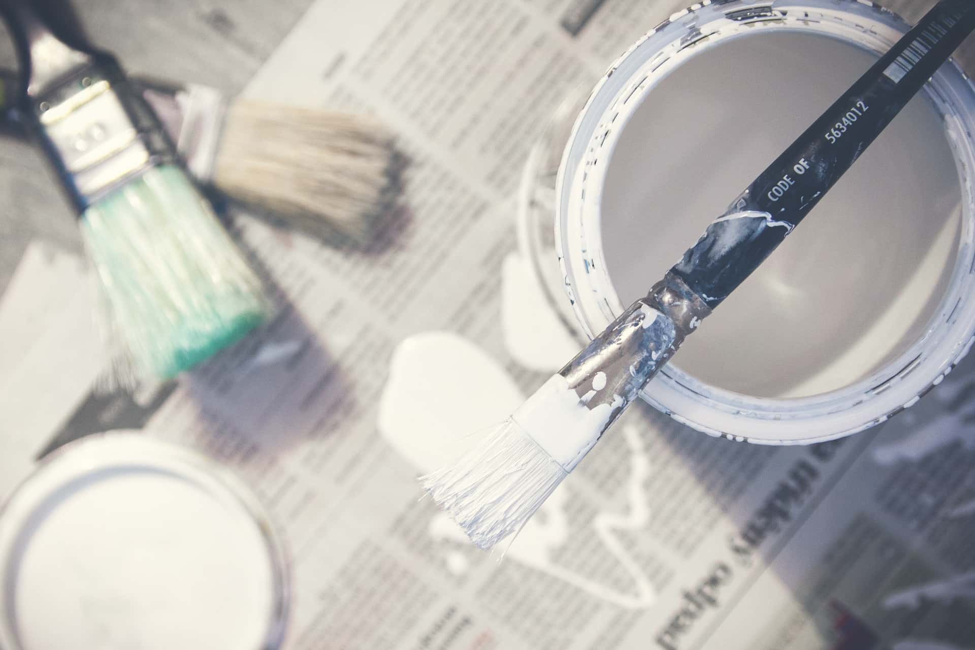 white paint pot and brushes